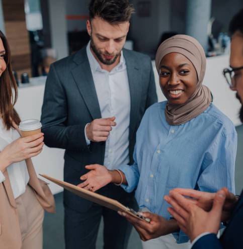 Business people discussing work in office during coffee break